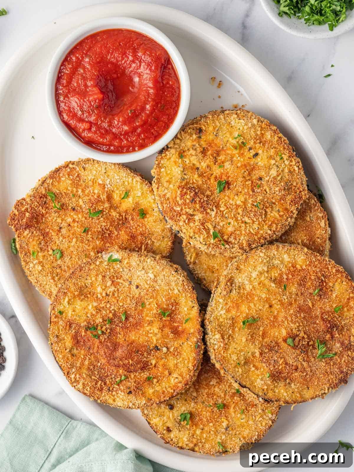 Crispy Air-Fried Eggplant Slices: Quick Restaurant-Style Recipe 2 A platter of air fried eggplant with marinara.