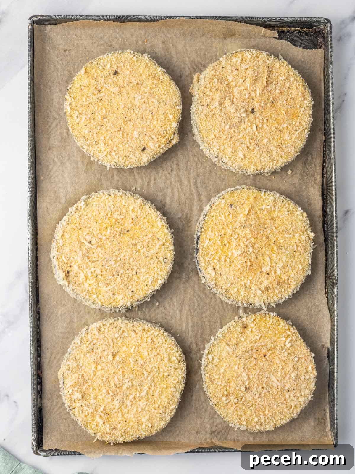 Crispy Air-Fried Eggplant Slices: Quick Restaurant-Style Recipe 6 Breaded eggplant ready to be air fried.