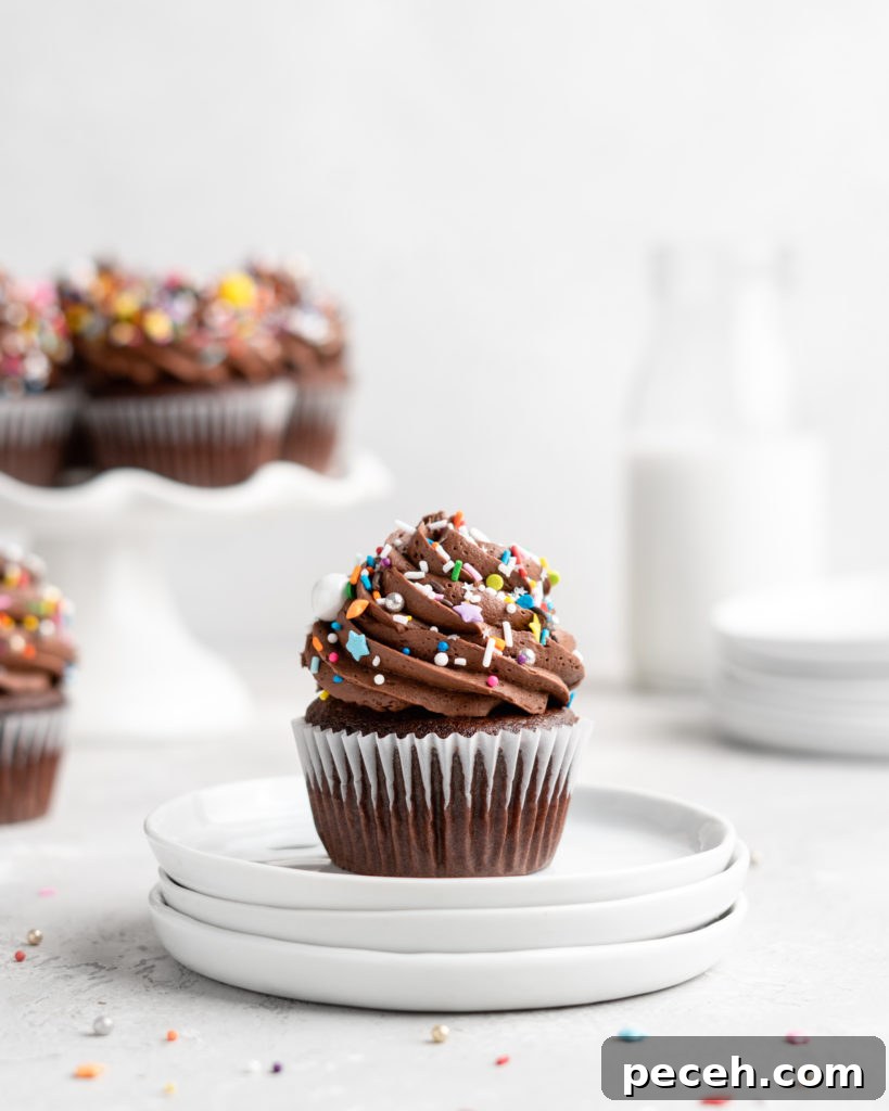 These Chocolate Cupcakes are moist and fluffy, and jam-packed with rich chocolate flavor! Topped with a rich, buttery chocolate buttercream