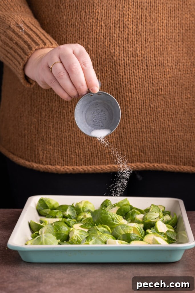 Maple-Balsamic Roasted Brussels Sprouts Recipe for Fall sides 6 Seasoning brussels sprouts with salt before roasting.