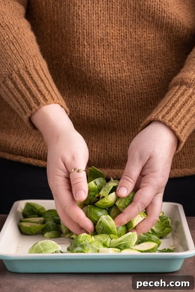 Maple-Balsamic Roasted Brussels Sprouts Recipe for Fall sides 7 Tossing brussels sprouts in oil and seasoning to prepare for roasting.