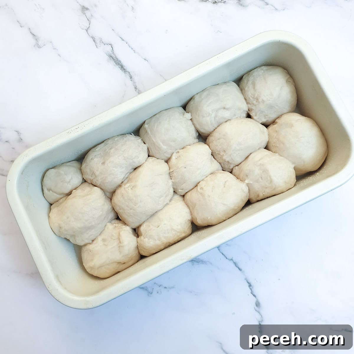 Mosbolletjies (Condensed Milk Rusks): South African Sweet Biscuits 11 Balls of dough packed into a baking tin.