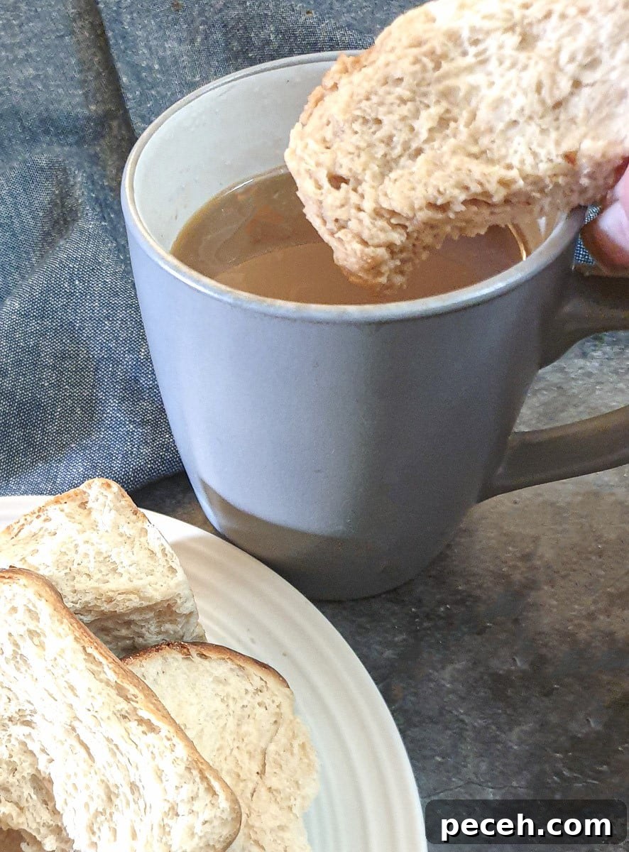Mosbolletjies (Condensed Milk Rusks): South African Sweet Biscuits 15 A dried rusk being dunked into a cup of coffee.