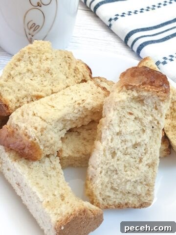 A pile of buttermilk rusks next to a striped blue and white cloth.