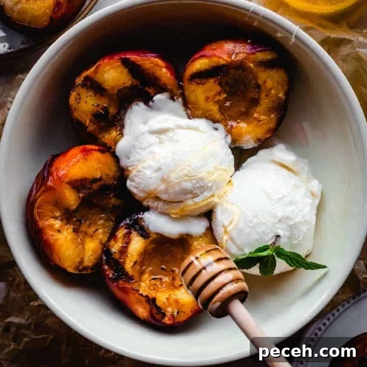 grilled peaches with scoops of vanilla ice cream being drizzled with honey