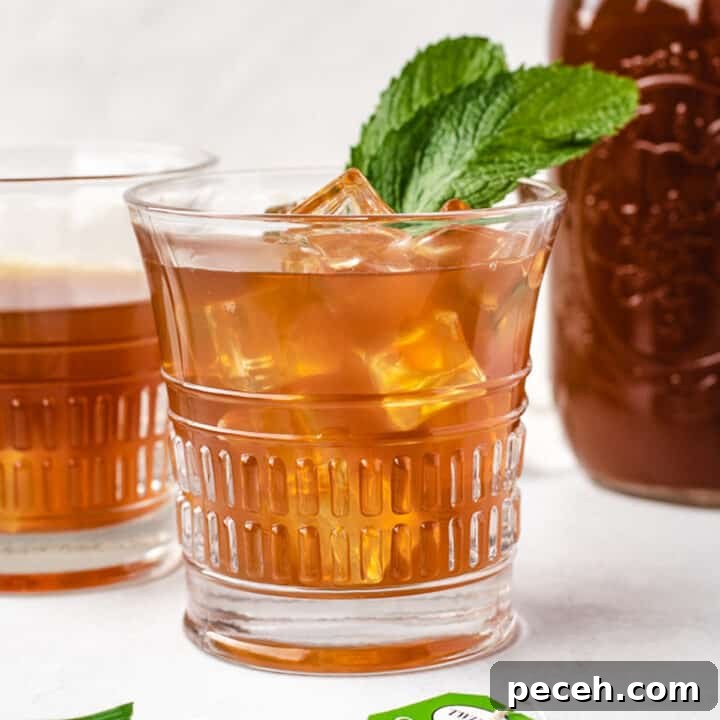 Glass of mint iced tea made using tea bags.