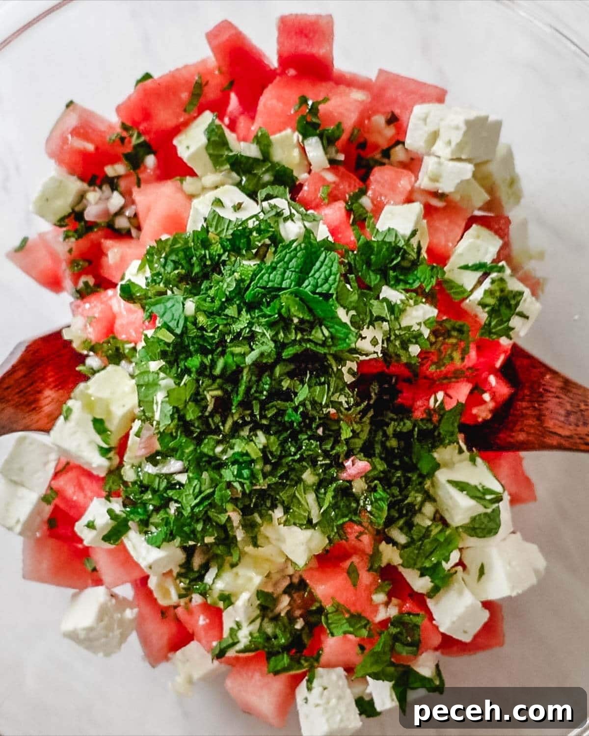 Cubes of fresh watermelon, feta cheese, and chopped mint.