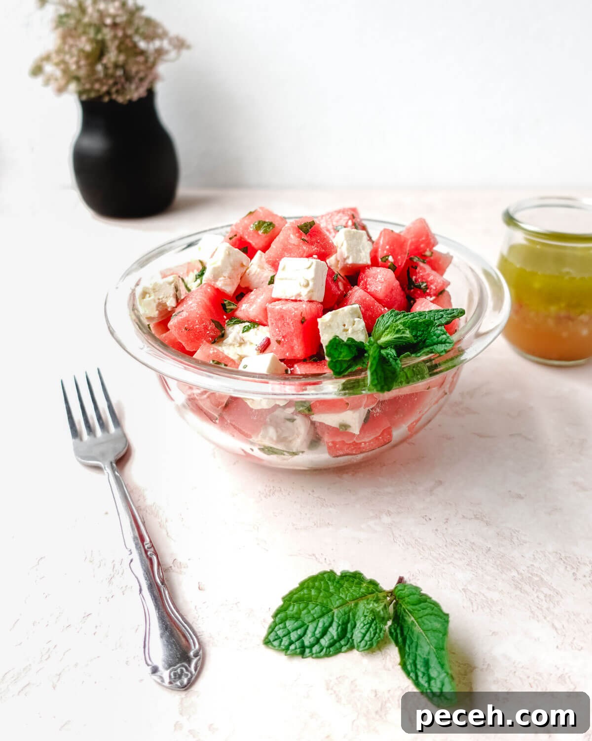 Serving watermelon feta salad with mint.