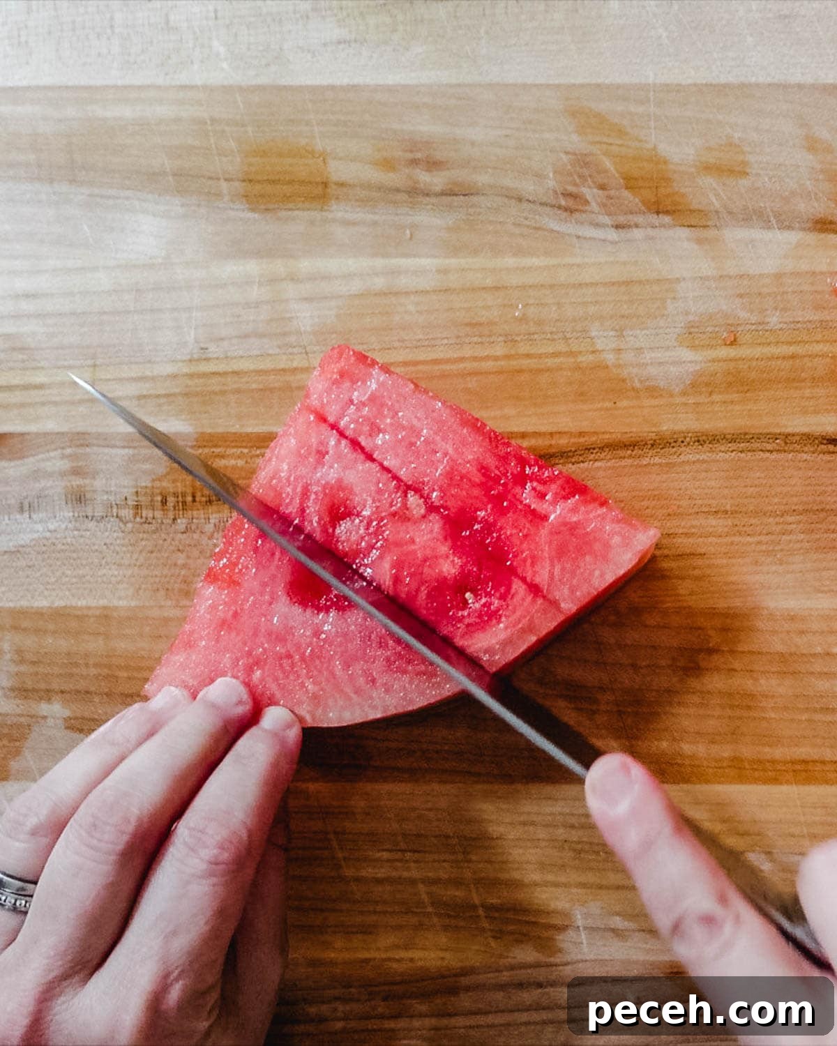 Watermelon being cut into cubes.