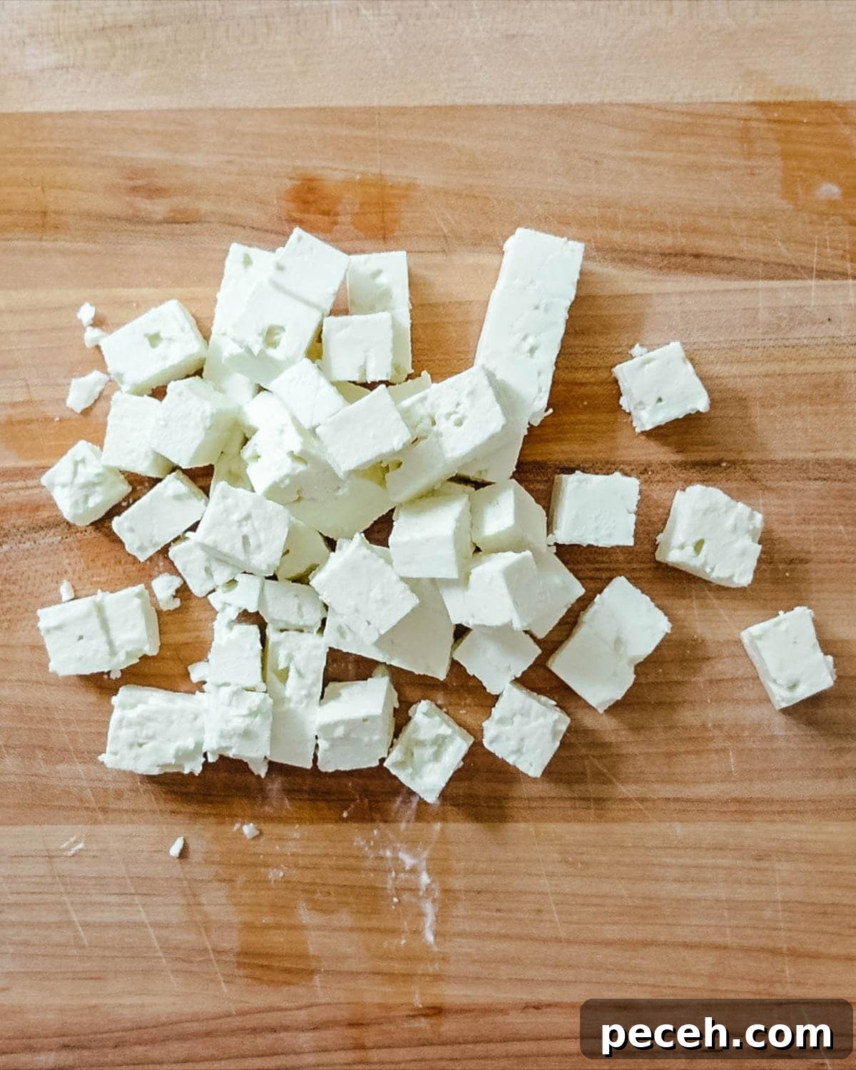 Feta cut up into cubes on a cutting board.