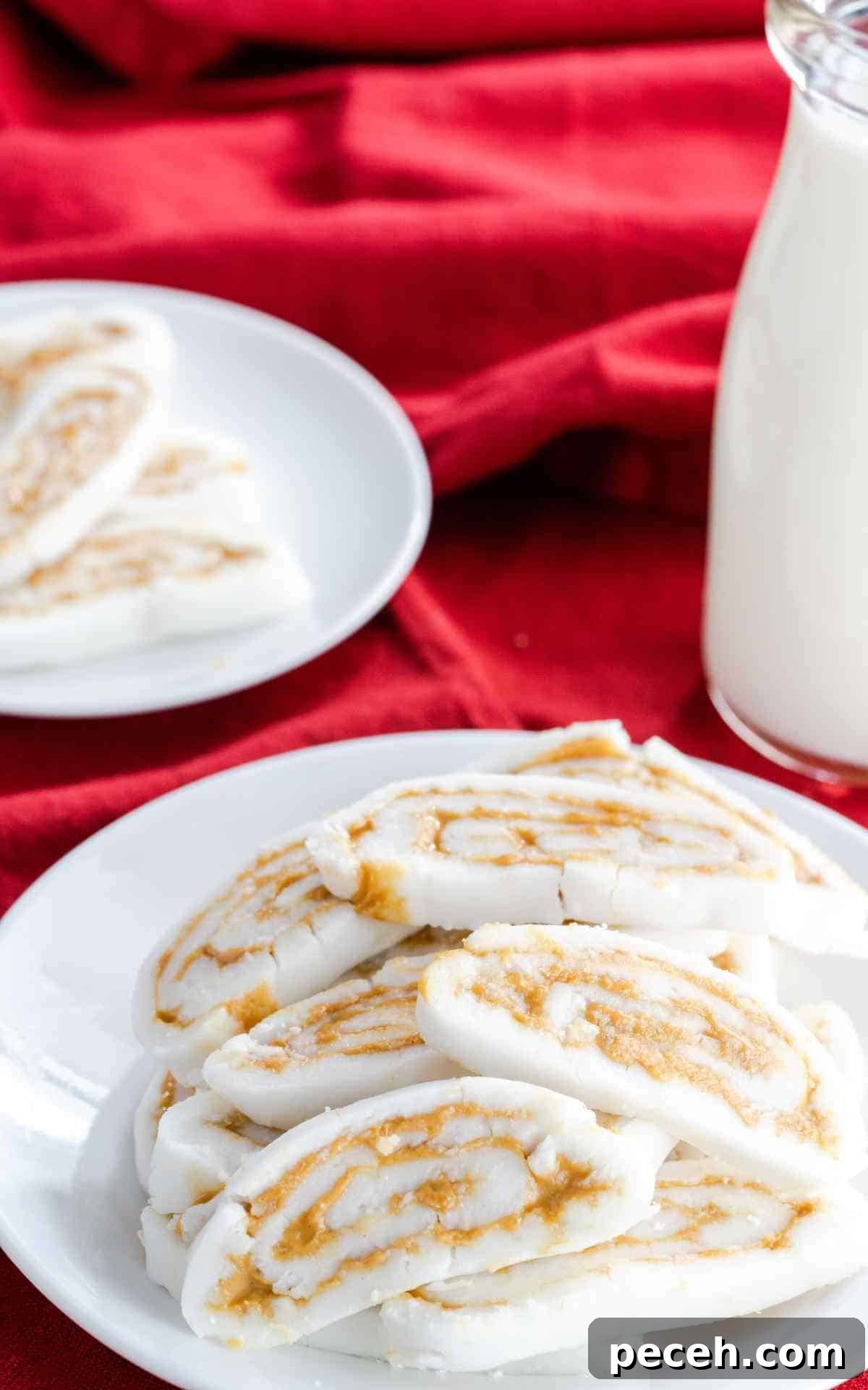 A plate of old fashioned potato candy with a glass of milk.