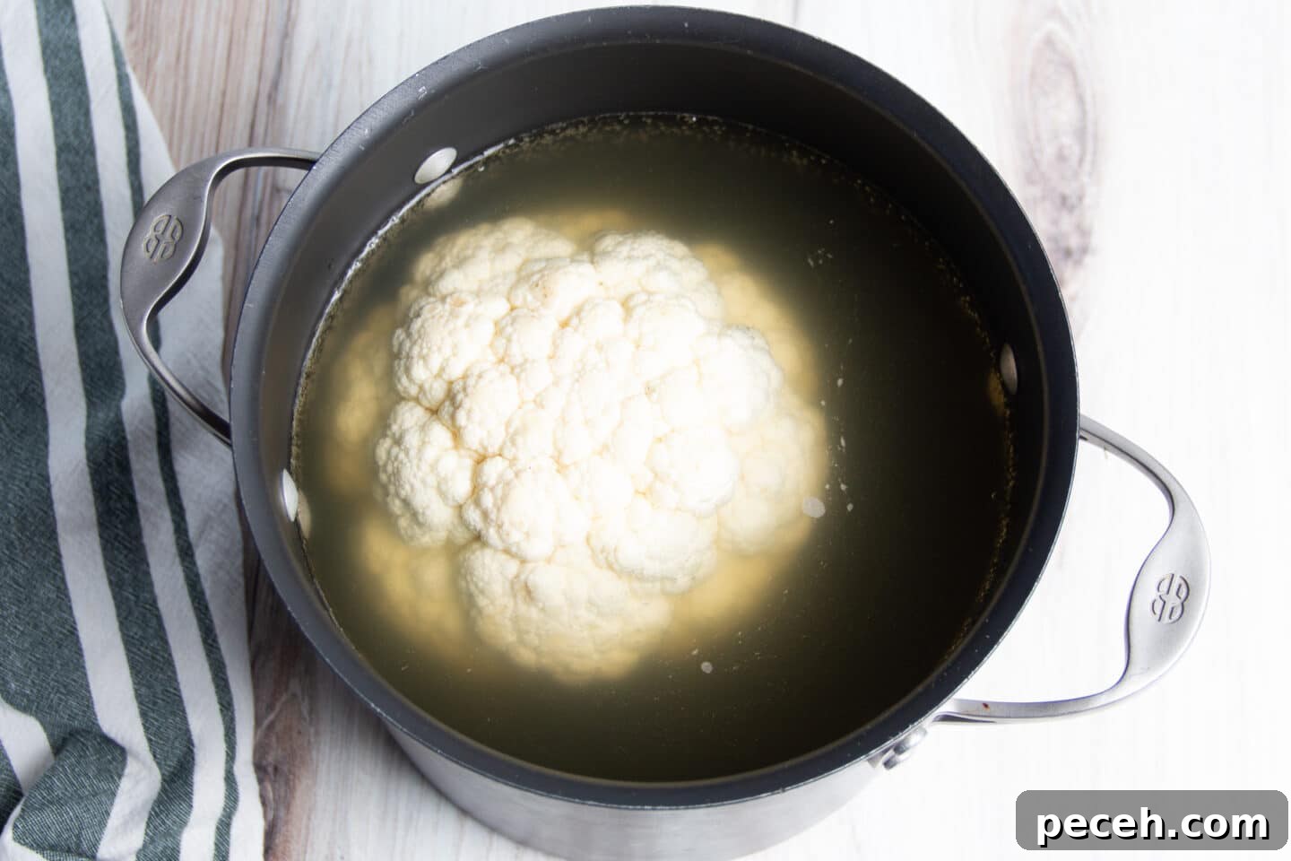 Smoked Cauliflower Recipe: Tender, Smoky Vegetable Side Dish 5 Picture of cauliflower in big pot filled with broth.