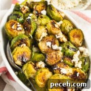 This is a square picture of a bowl of Brussels sprouts with feta and balsamic glaze.
