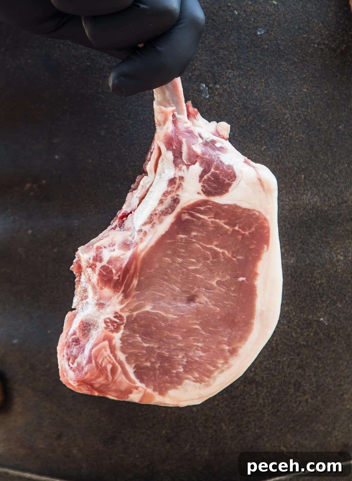 Pork Chops Explained: Types, Cooking Tips, and Serving Ideas 4 A raw pork t-bone steak