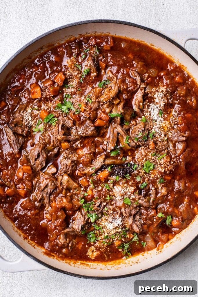 Braised Beef Short Rib Ragu Recipe — Slow-Cooked Italian Comfort 11 The meat stirred back into the braising liquid to form a ragu sauce.
