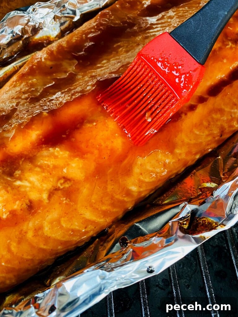Honey Sriracha Salmon on the Traeger Grill: Sticky Spicy Glaze Recipe 5 brushing with more sauce