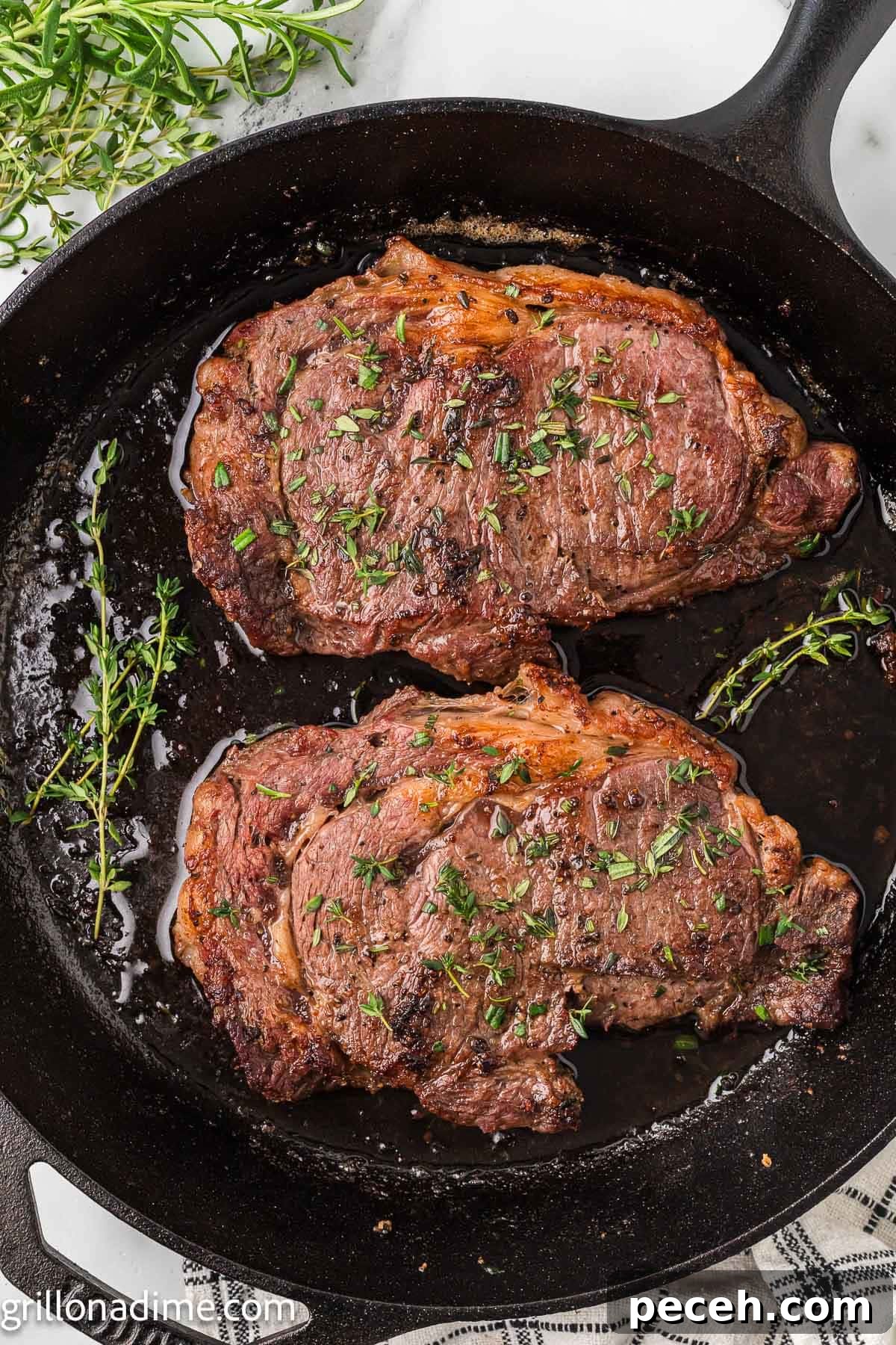 Perfect Cast-Iron Steak: Searing Tips for Juicy, Flavorful Results 2 Steak and fresh herbs in a cast iron skillet