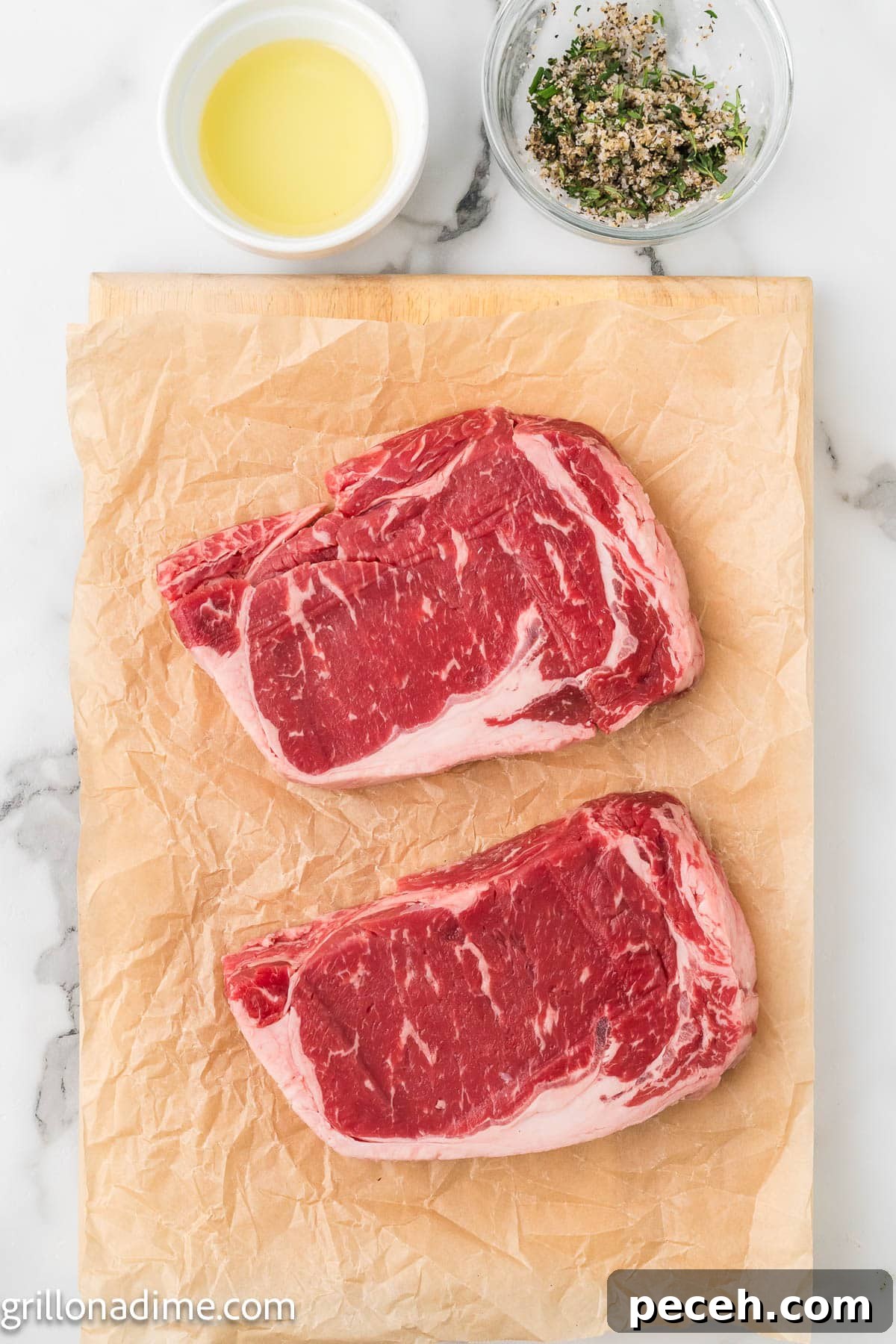 Perfect Cast-Iron Steak: Searing Tips for Juicy, Flavorful Results 4 Steak on parchment paper with a bowl of melted butter and fresh herbs