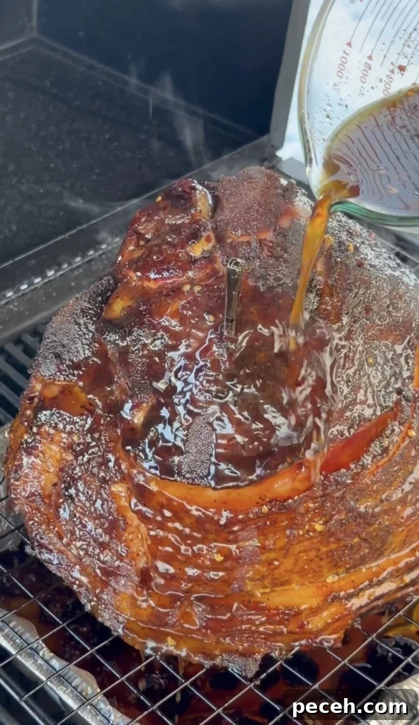 Classic Christmas Glazed Ham Recipe for Holiday Dinner 9 glaze being poured on the ham