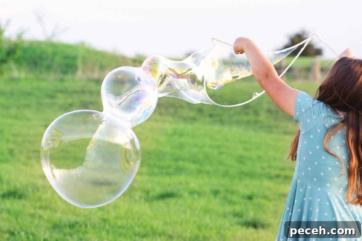 How to Make Long-Lasting Soap Bubbles with Glycerin 3 a girl making giant bubbles with a bubble wand