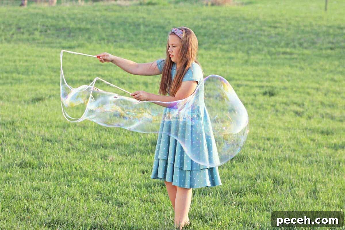 How to Make Long-Lasting Soap Bubbles with Glycerin 7 a girl making giant bubbles with a bubble wand