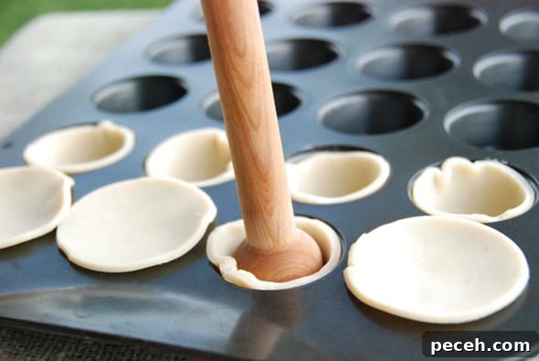 Mini Pumpkin Pies: Perfect Single-Serve Fall Desserts 5 pressing pastry in pan.