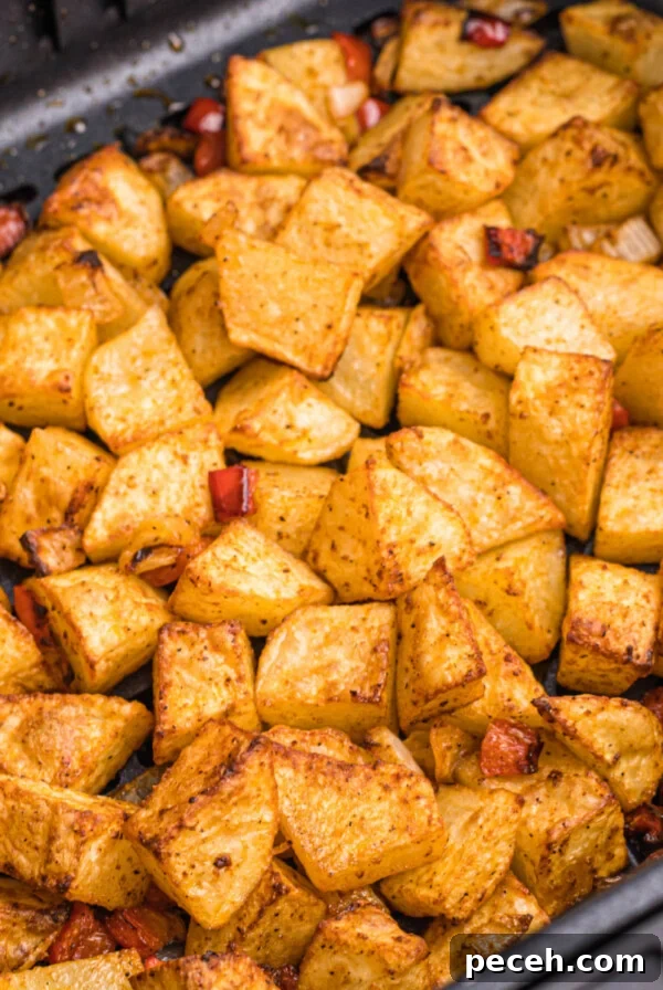cooked home fries in the basket of the air fryer.