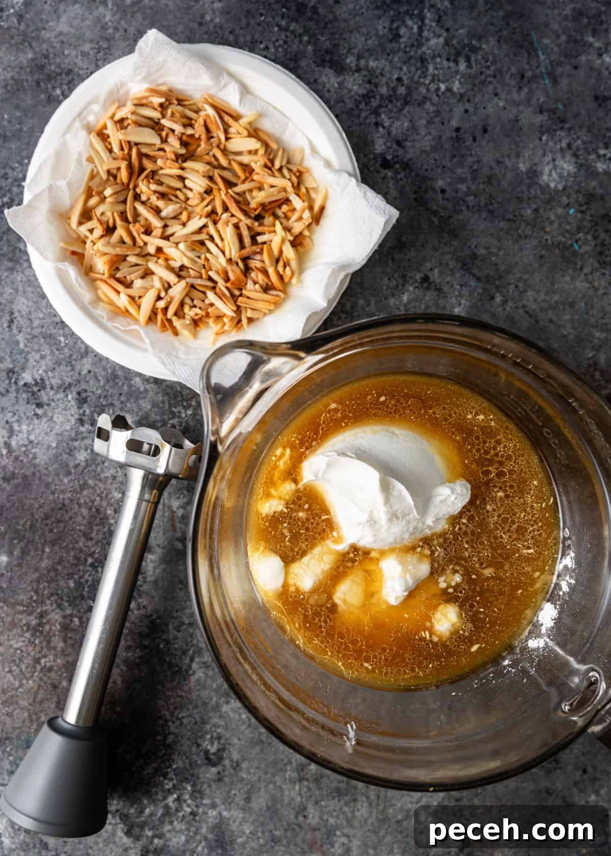 Authentic Jordanian Mansaf Recipe: Traditional Bedouin Feast 8 overhead process shot: ingredients to make this jameed sauce in measuring cup with hand mixer and bowl of diced almonds on side