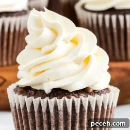 7-Minute Frosting Recipe: Light, Fluffy Meringue Icing 5 cupcakes topped with Cool Whip Frosting on a wooden tray