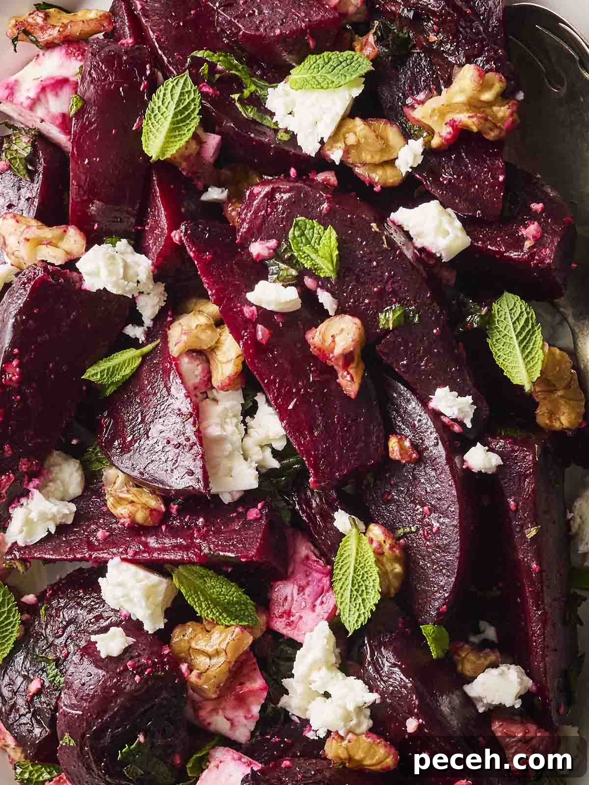 A close up of a Beetroot Salad with feta, mint and walnuts.