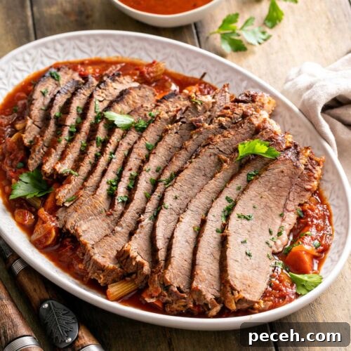 Tender sliced brisket of beef on a bed of vegetables and sauce