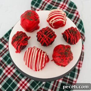 Decadent Christmas Truffles: Festive Homemade Chocolate Treats 12 Red, white, and green decorated chocolate truffles on a white serving platter.