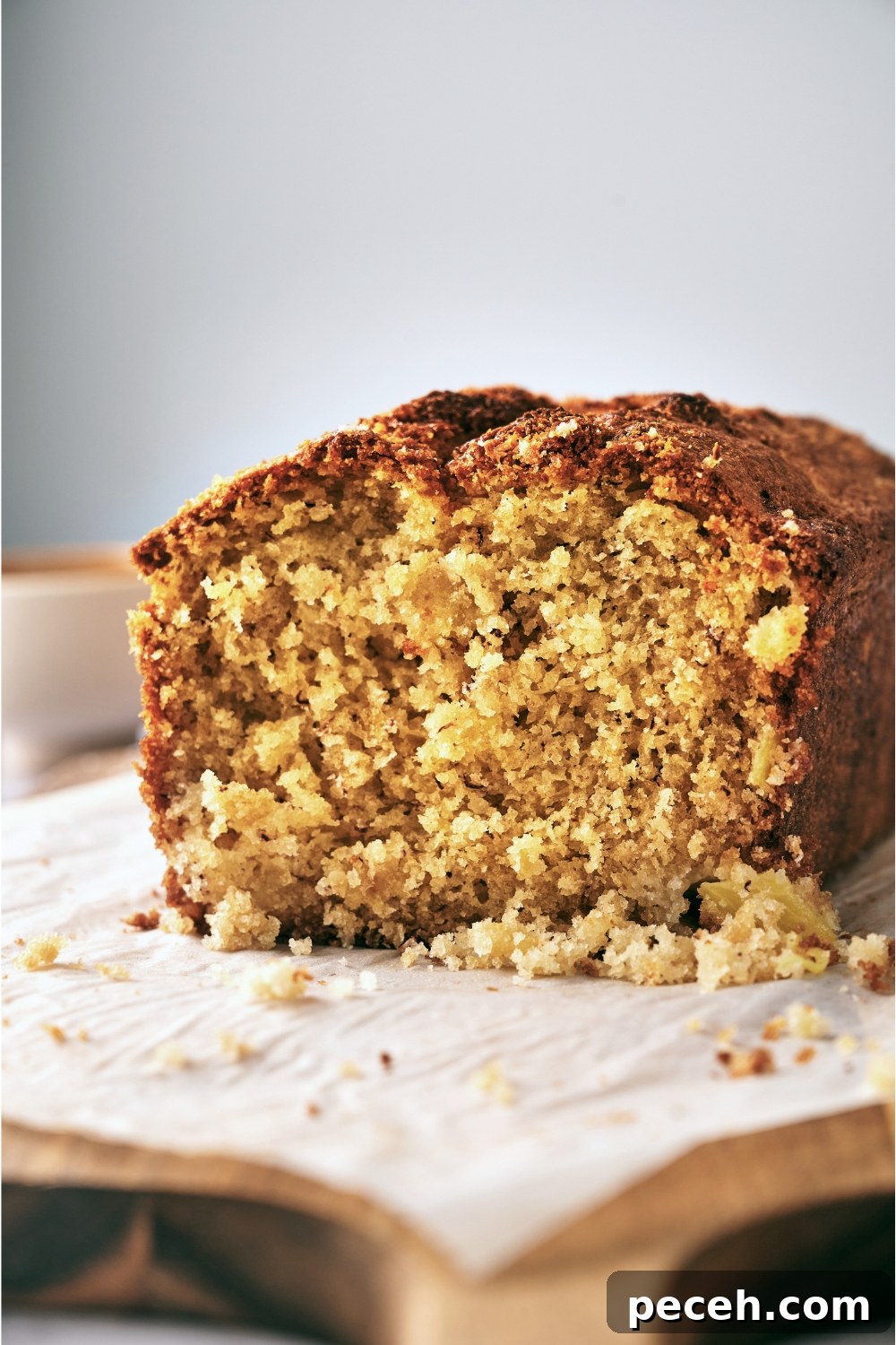 Tropical Hawaiian Banana Bread with Coconut and Macadamia Nuts 12 A wooden serving tray with a half a loaf of banana bread.