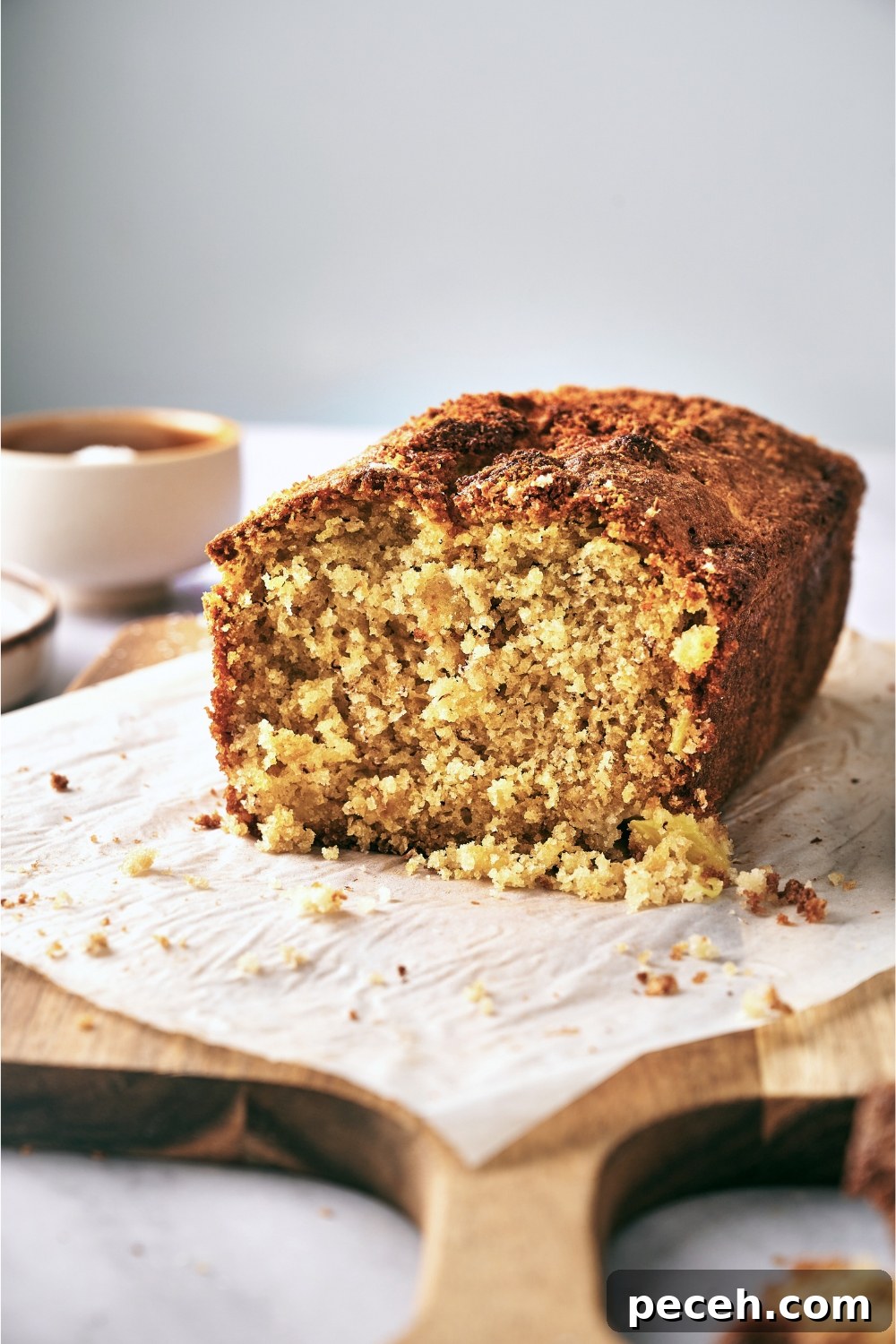 Tropical Hawaiian Banana Bread with Coconut and Macadamia Nuts 4 A wooden serving tray with a half a loaf of banana bread.