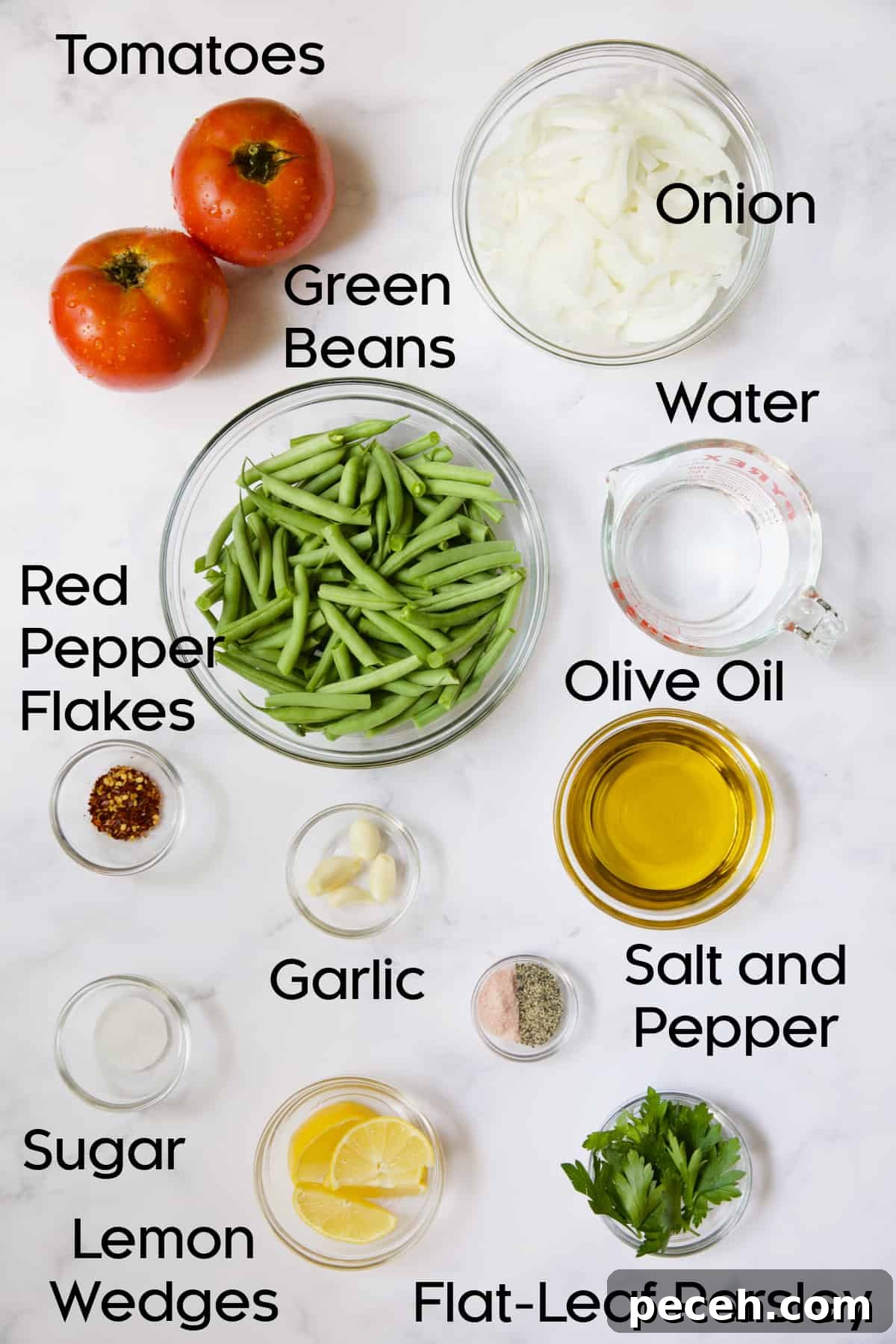 Ingredients for Mediterranean Braised Green Beans with Tomatoes in glass bowls.