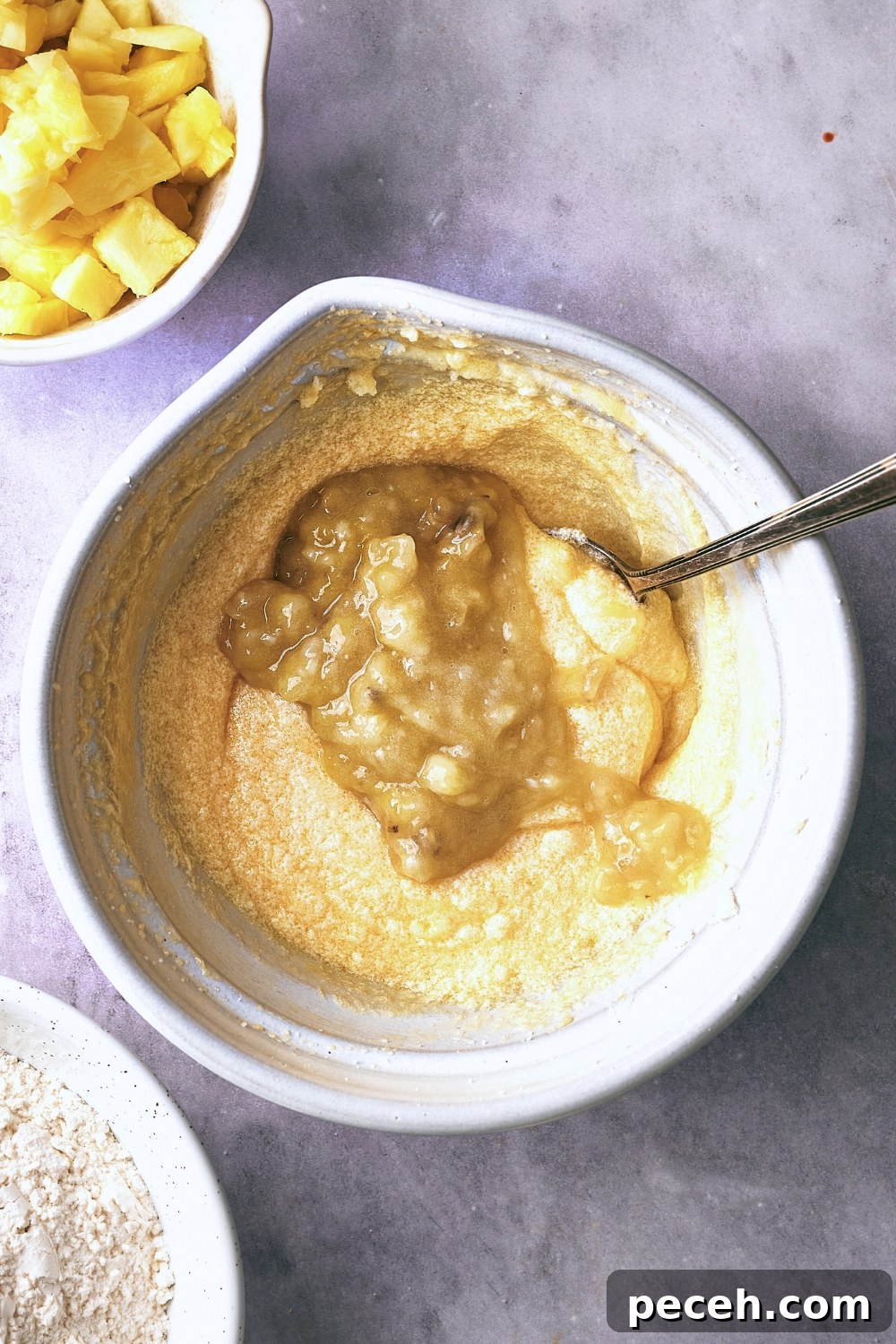 Tropical Hawaiian Banana Bread with Coconut and Macadamia Nuts 7 A mixing bowl with the wet ingredients and mashed bananas being mixed.