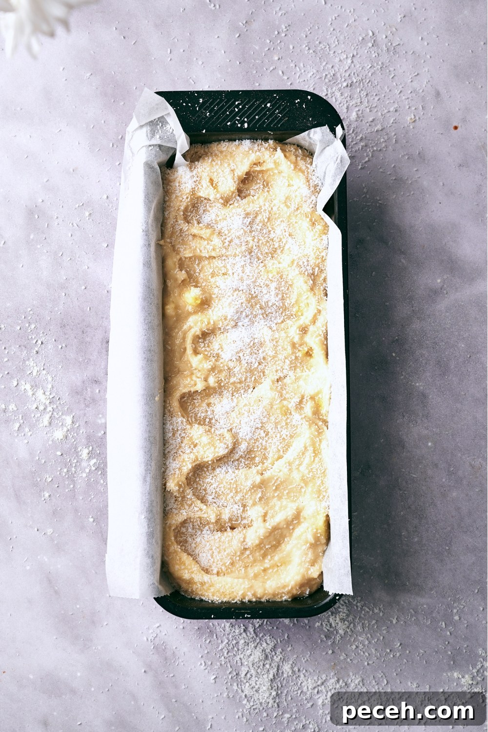 Tropical Hawaiian Banana Bread with Coconut and Macadamia Nuts 10 A loaf pan with unbaked Hawaiian banana Bread batter.
