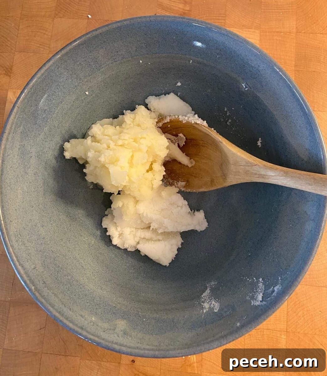 Chewy Vegan Molasses Snap Cookies 4 Mashed potatoes, shortening and sugar in a bowl with a wooden spoon.