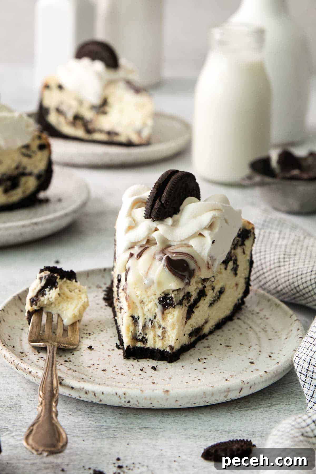 A slice of gluten-free Oreo cheesecake on a plate with a fork
