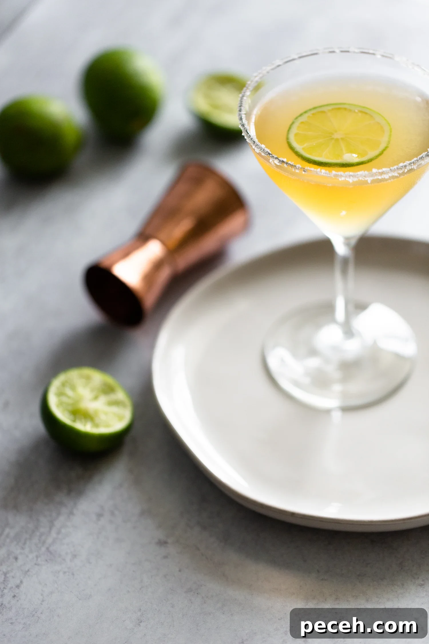 Italian Margarita in a martini glass with a lime wheel. Italian Margarita with a slice of lime