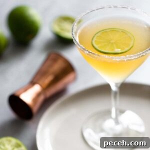 Italian Margarita Cocktail Recipe: Classic Twist on a Margarita 2 Italian margarita in a martini glass with a lime slice.