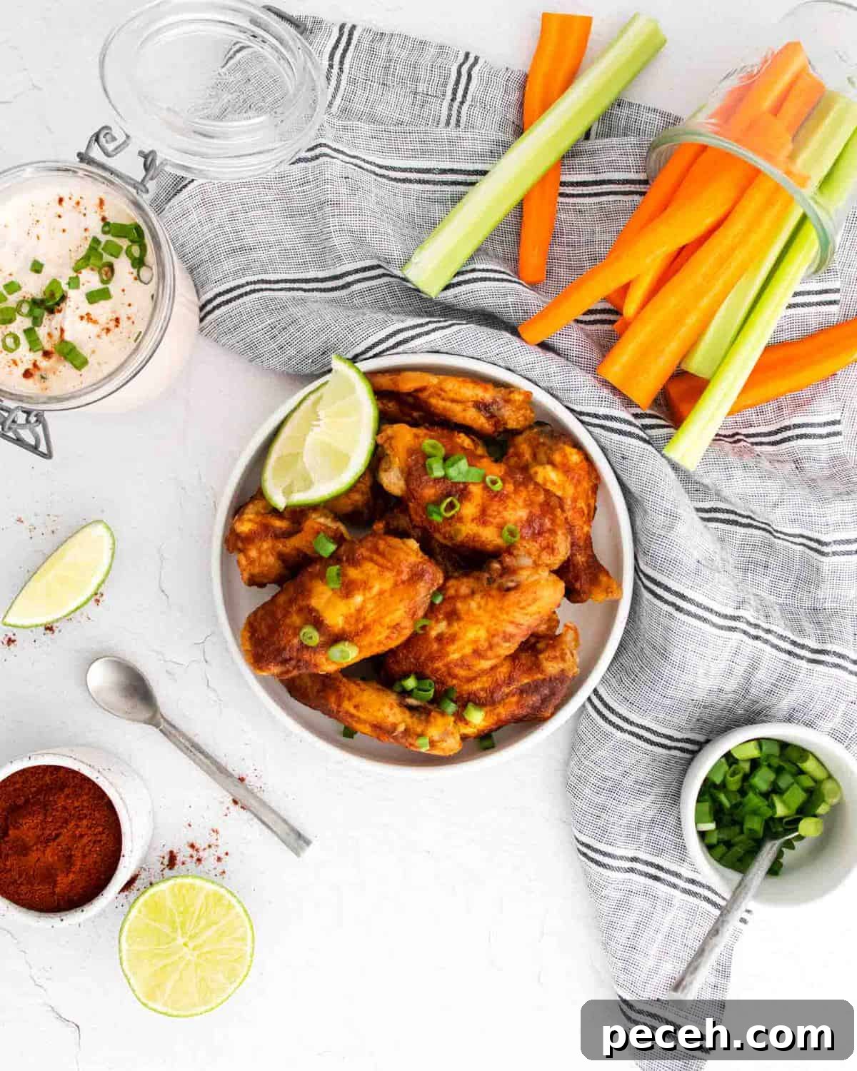 Chili Lime Chicken Wings with Tangy Dipping Sauce 3 Overhead view of glazed wings, carrots, celery, and dipping sauce.
