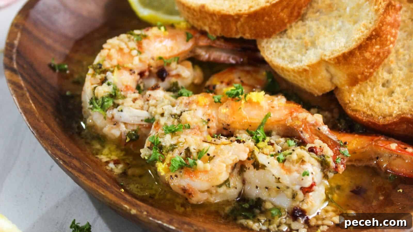 Grilled shrimp with garlic and herbs served with slices of toasted bread.