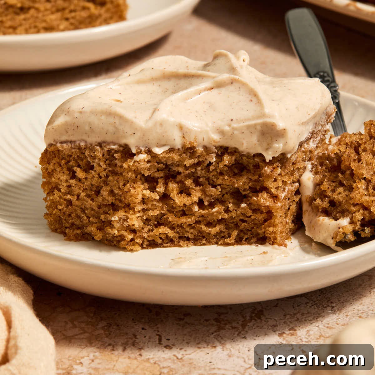 Vegan Chai-Spiced Layer Cake Recipe 14 A piece of vegan chai spice cake on a plate with a forkful removed.