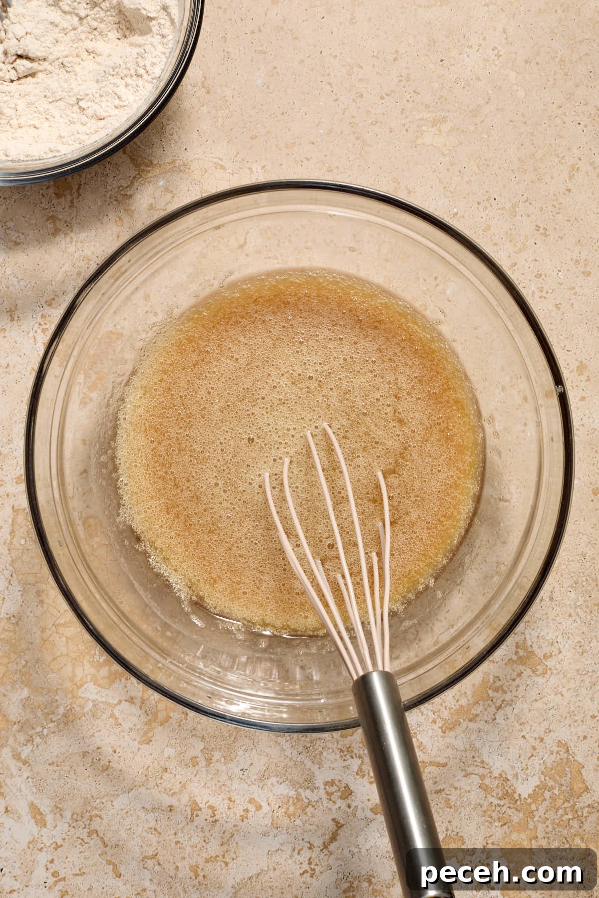 Vegan Chai-Spiced Layer Cake Recipe 7 Wet ingredients whisked together in a glass bowl with dry ingredients off to the side.