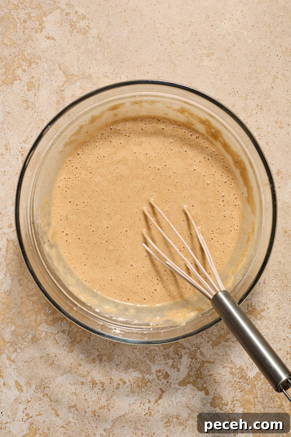 Vegan Chai-Spiced Layer Cake Recipe 8 Batter mixed together in a glass bowl with a whisk.