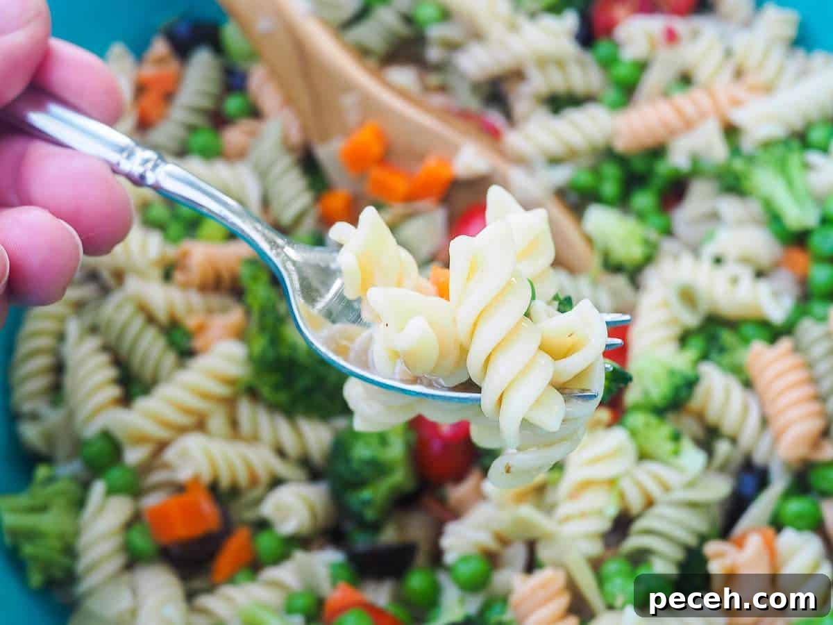 A bite of pasta salad on a fork.