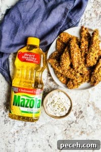 Pistachio Crusted Baked Chicken Tenders ready in 30 minutes Chicken tenders on a white counter with a purple napkin.