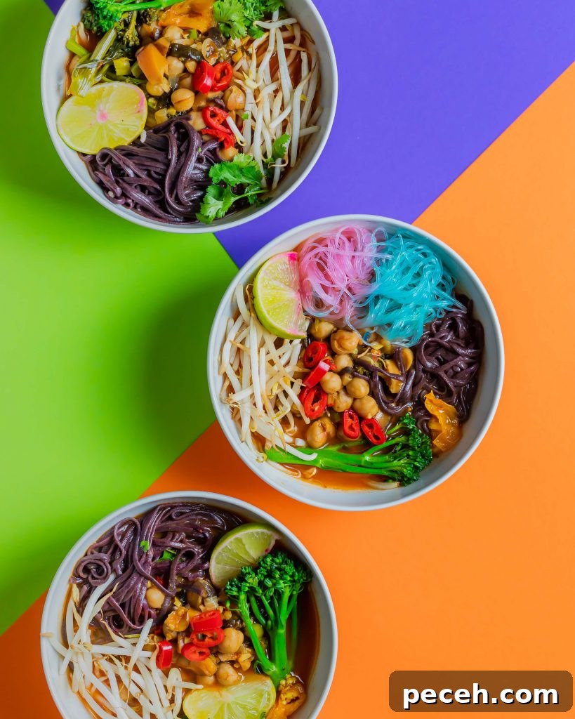 Three bowls containing the spicy soup, displayed on a colourful background.