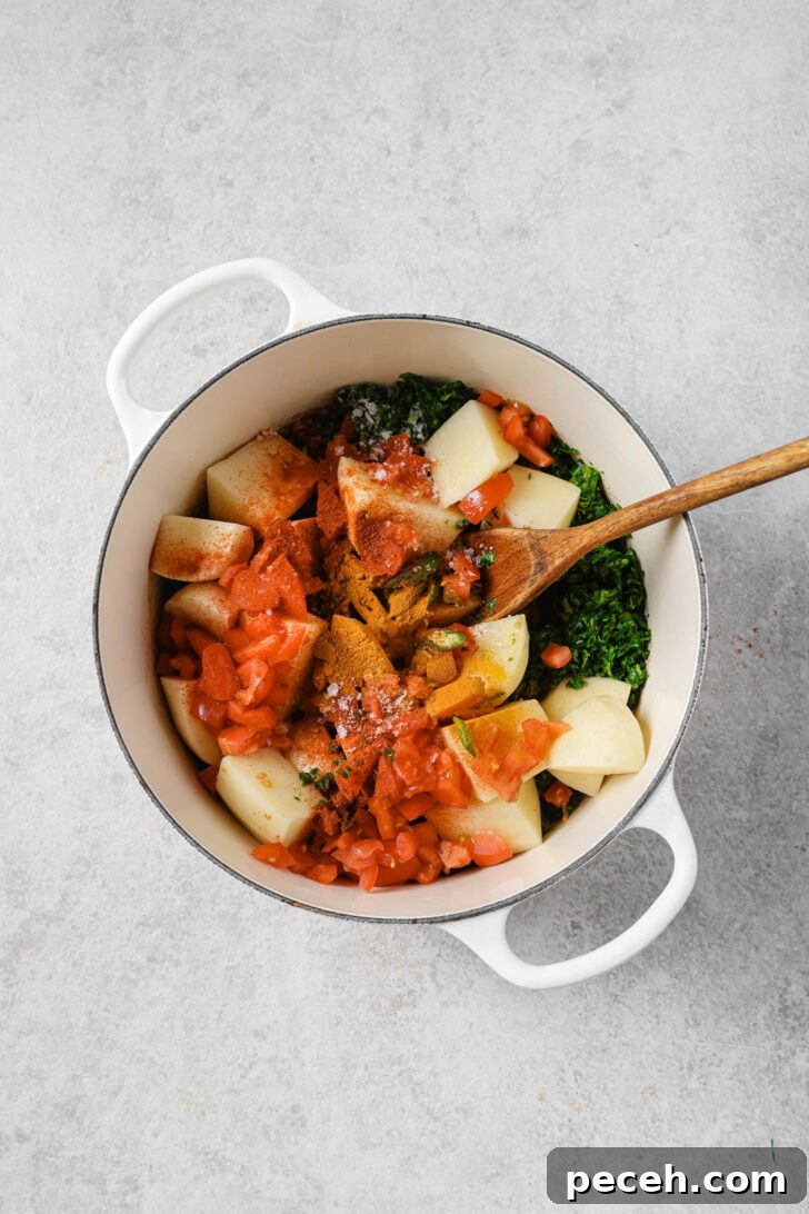 Authentic Aloo Methi (Potato & Fenugreek Leaves) Recipe from Mom-in-Law 11 Potatoes, tomatoes, green chilli and spices added to pot with chopped fenugreek leaves.